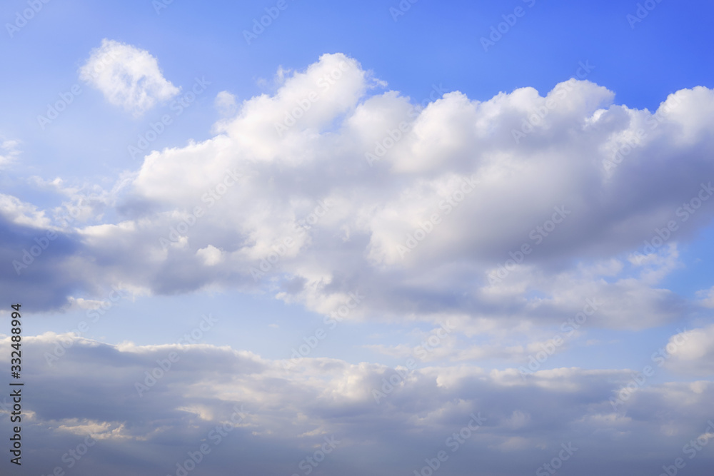 Background clouds on blue sky, copy space. White Cumulus clouds in clear weather. The sky on a sunny summer day. Background clouds on blue sky, copy space. White Cumulus clouds in clear weather. The sky on a sunny summer day.