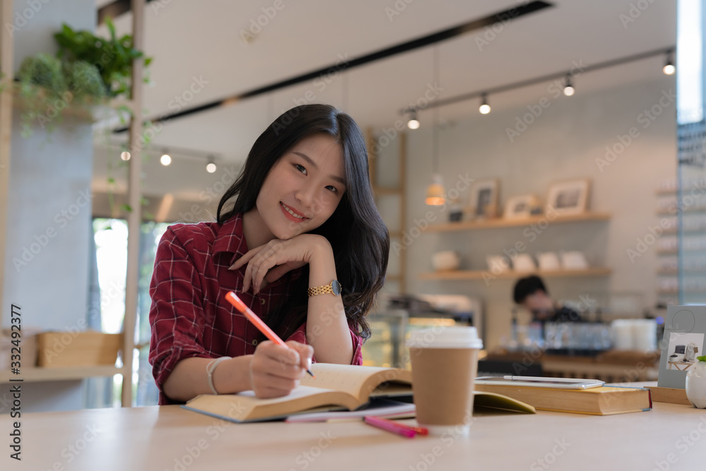 Close up of young business woman big smiling from ear to ear while holding tablet in her hand at table, successful concept Close up of young business woman big smiling from ear to ear while holding tablet in her hand at table, successful concept