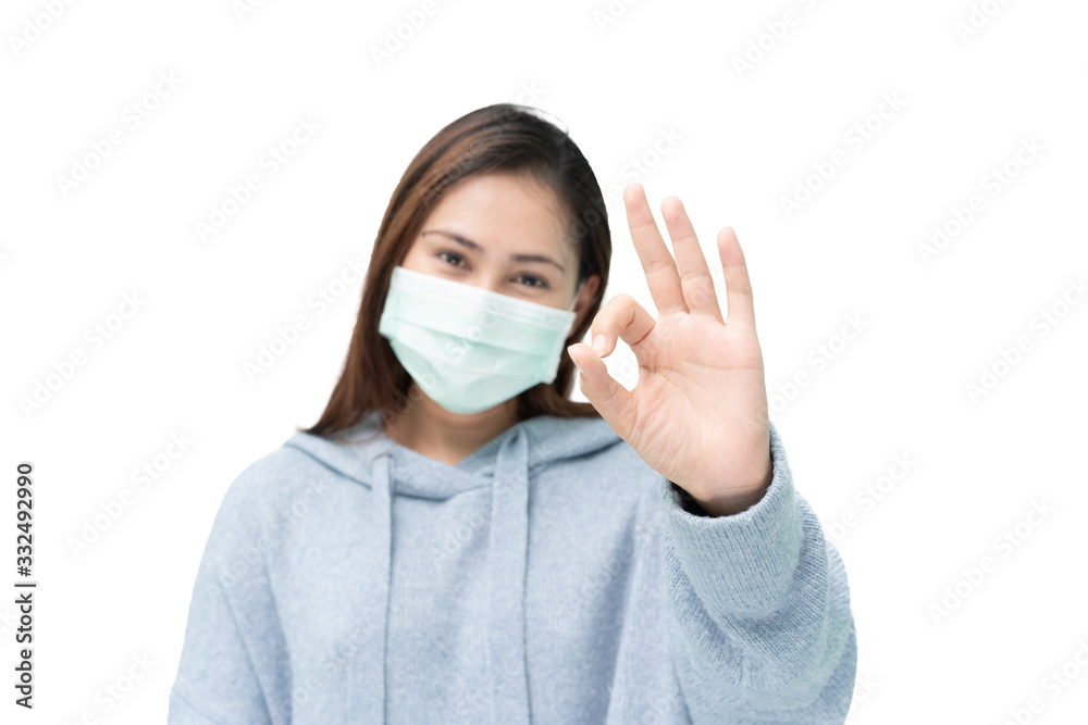 Girl wearing mask again flu and covid-19,corona virus and make ok hand sign Girl wearing mask again flu and covid-19,corona virus and make ok hand sign