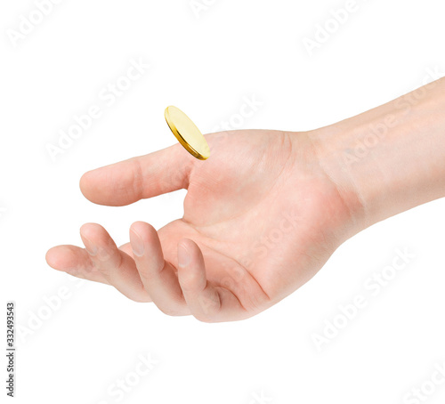 Gold coin falls into a man's hand on a white background.