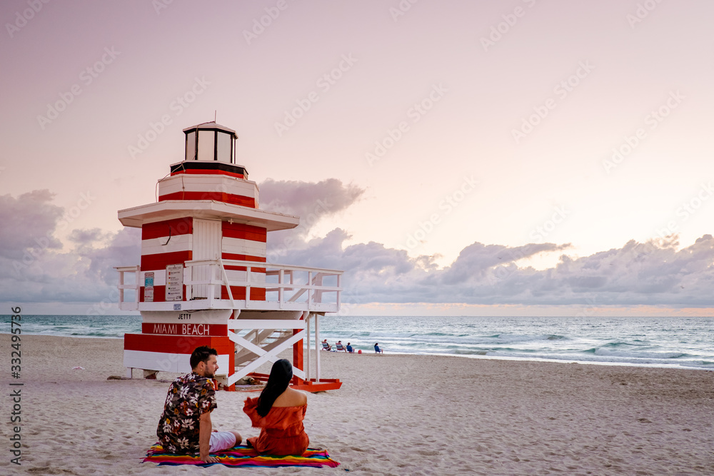 Naklejka premium Miami Beach,young couple at the beach of Miami Florida, mid age couple men and woman at the beach 