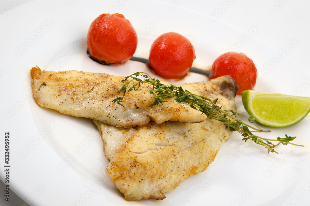 Appetizing grilled fish with vegetables isolated on white background Appetizing grilled fish with vegetables isolated on white background