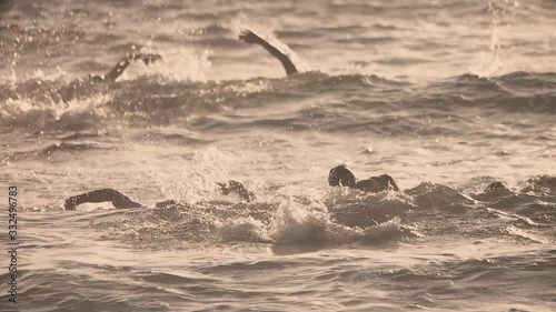 Slow-motion of athletes or swimmers swimming in the ocean