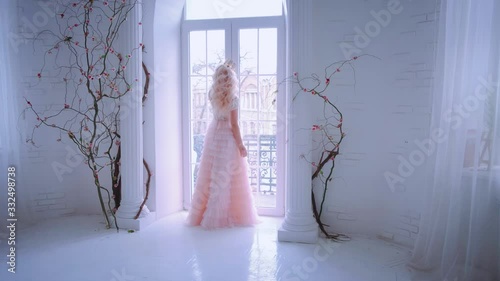 Silhouette beautiful woman. blonde long hair, gold crown on head. Sad Princess touching window. Stay by window looks out. hostage castle. Concept of quarantine to stay home. go crazy with boredom.