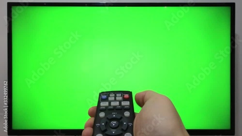 background; movie; thumb; program; modern; finger; controller; equipment; chroa key; green screen; push; video; holding; on; off; ok. communication; human; watching; wireless; relax; broadcasting; dis