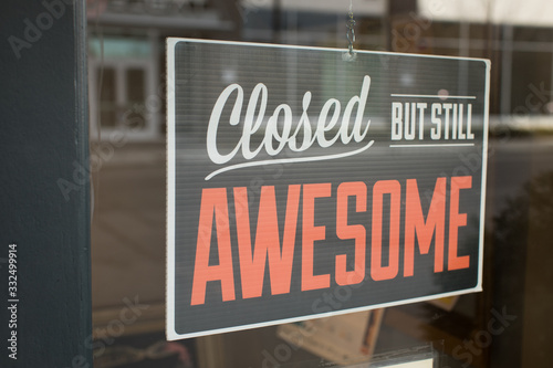 Closed but still awesome sign hanging in business window