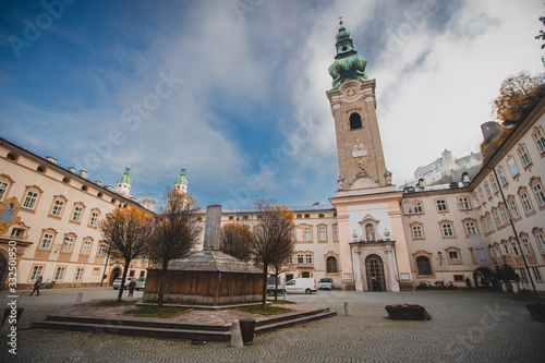 Square of saint peter or sankt peter in front of Kloster in Salzburg, Austria, with visible castle or fortress in the background.