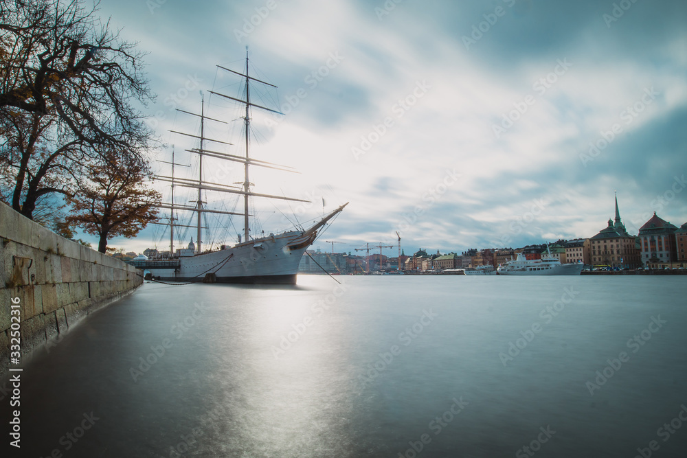 Hostel ship or sailboat of Af Chapman in Stockholm in front of Katarina - Sofia area in the background on a cloudy rainy autumn day.