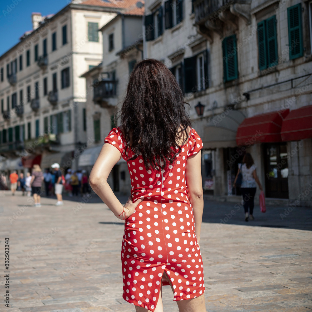 Montenegro - A young woman observing the architecture of Kotor Old Town