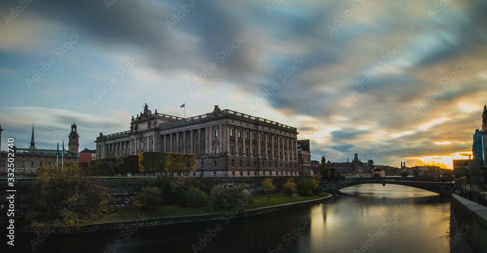 Swedish parliament house Riksdag, with its neoclassical facade in downtown Stockholm on a sunny autumn day. Long exposure mystical photo during sunset