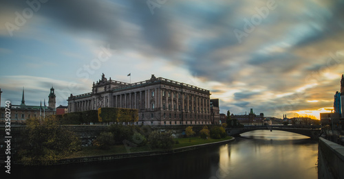 Swedish parliament house Riksdag, with its neoclassical facade in downtown Stockholm on a sunny autumn day. Long exposure mystical photo during sunset © Anze