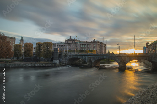 Swedish parliament house Riksdag, with its neoclassical facade in downtown Stockholm on a sunny autumn day. Long exposure mystical photo during sunset