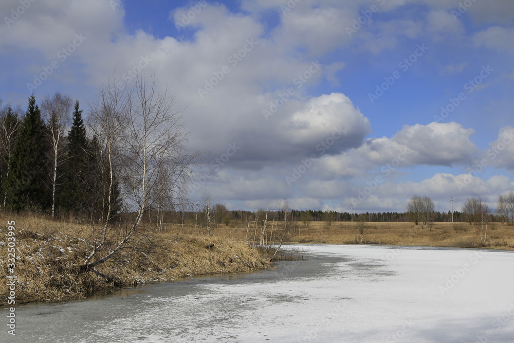 Landscape with small iced lake in sunny spring day Landscape with small iced lake in sunny spring day