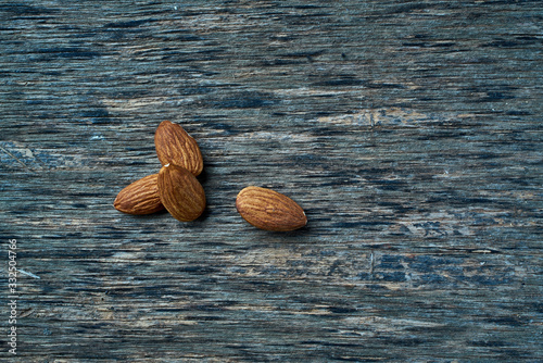 From above tasty fresh gathered hazelnut on wooden spoon on linen at table