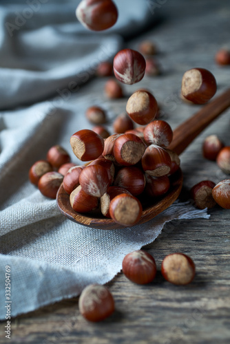 Brown ripe hazelnut on spoon at table photo