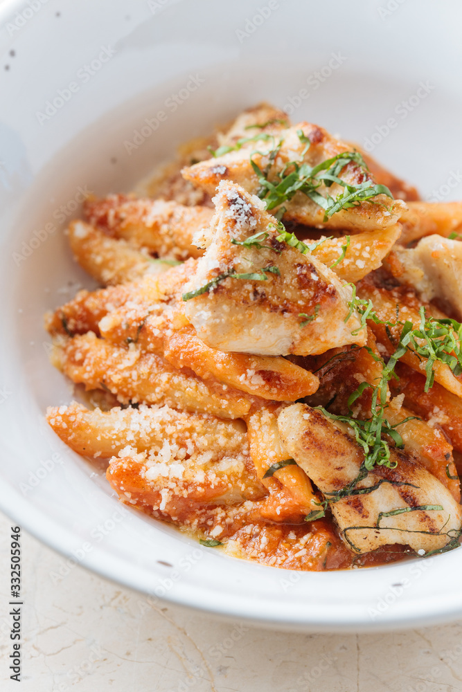 From above of delicious pasta served with cheese pieces of roasted meat and herbs in restaurant From above of delicious pasta served with cheese pieces of roasted meat and herbs in restaurant