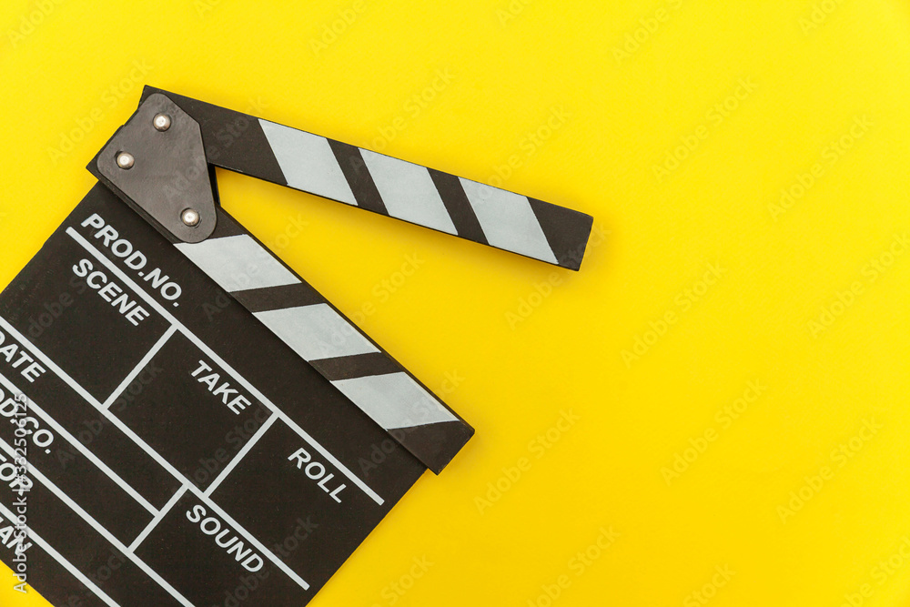 Filmmaker profession. Classic director empty film making clapperboard or movie slate isolated on yellow background. Video production film cinema industry concept. Flat lay top view copy space mock up.