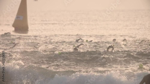 Slow-motion of athletes or swimmers swimming in the ocean photo