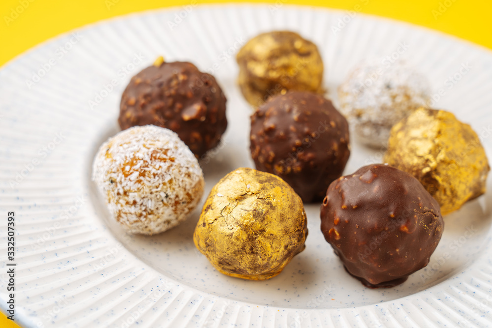 Closeup ball shaped nut cookies with various icing placed on ribbed plate Closeup ball shaped nut cookies with various icing placed on ribbed plate