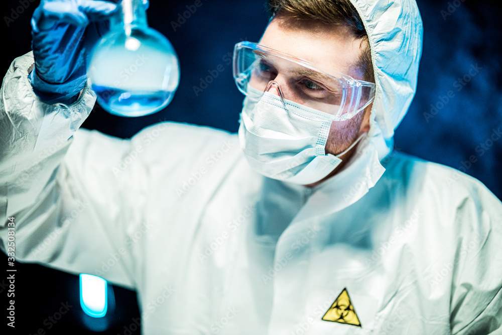 corona virus concept. male doctor reviewing glass flask