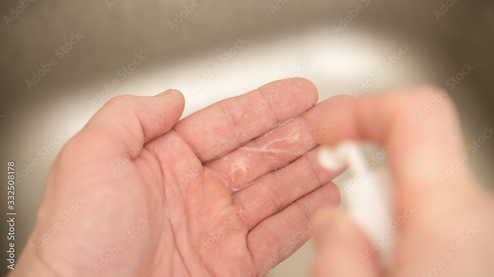 A man uses an antiseptic to disinfect hands A man uses an antiseptic to disinfect hands