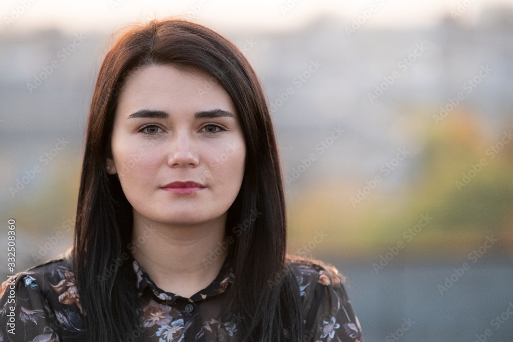 Portrait of a happy black haired woman on warm summer day outdoors. Portrait of a happy black haired woman on warm summer day outdoors.