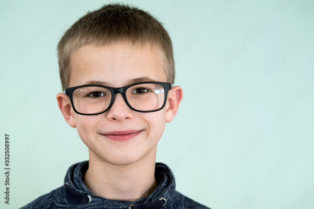 Close up portrait of a child school boy wearing glasses.