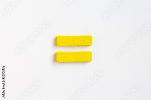 yellow painted wooden equal, craft sign for kid's education isolated, ecological concept