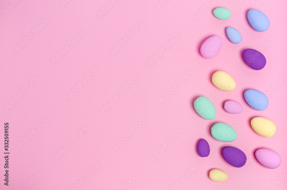 Easter eggs colored on a pink background, copy space, flat lay
