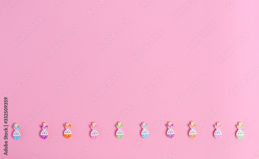 Decorative easter clothespins for decor on a pink background, copy space, flat lay Decorative easter clothespins for decor on a pink background, copy space, flat lay