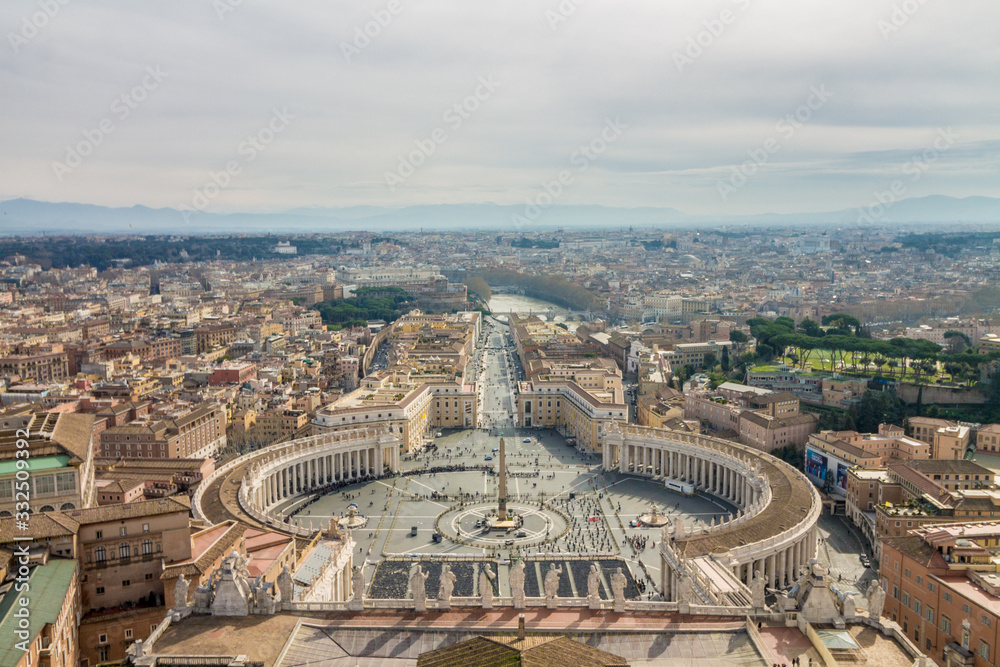 Obraz premium Aerial view of St Peter's square in Vatican City, Rome, Italy. Sunny spring day with clouds.