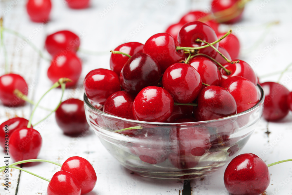 A small glass bowl with ripe fresh cherry A small glass bowl with ripe fresh cherry