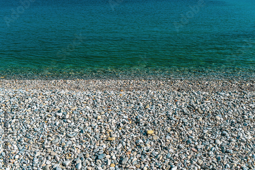 Textura of water and stones on the beach.