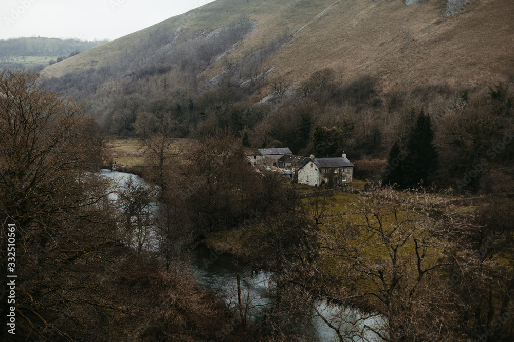 River flowing among mountain valley in gray day River flowing among mountain valley in gray day