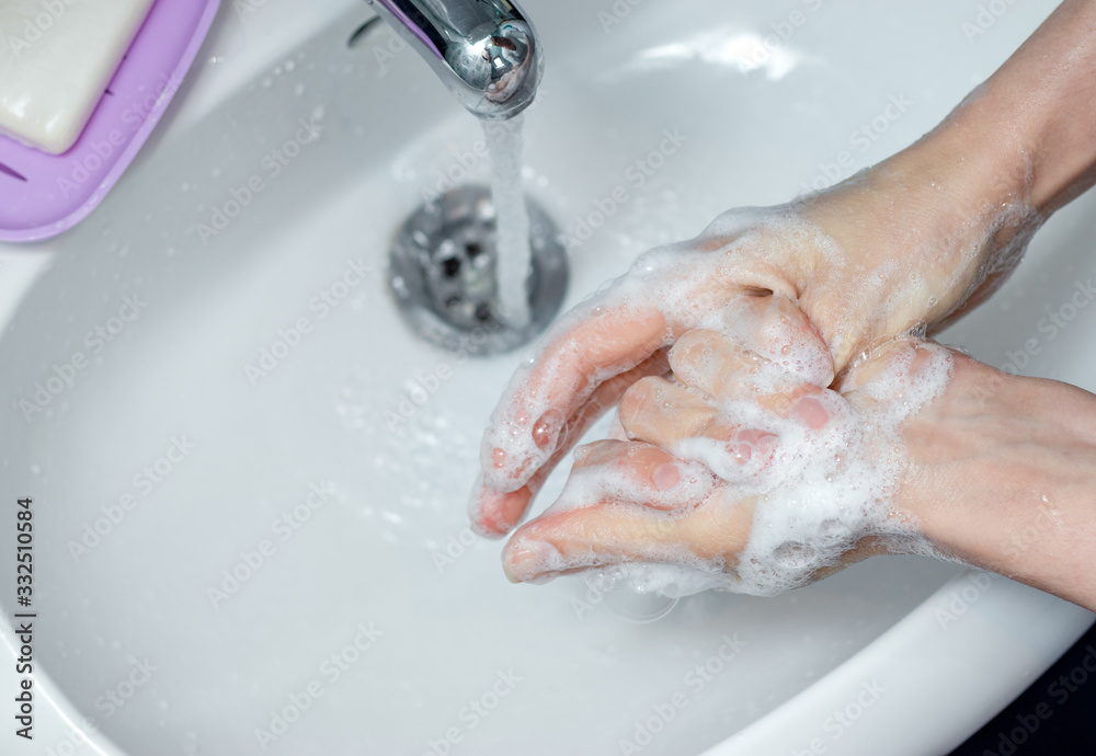 Woman washing hands with soap under the faucet in bathroom. Step by step picture instructions for thorough medical procedure. Step 7, wash the right thumb.