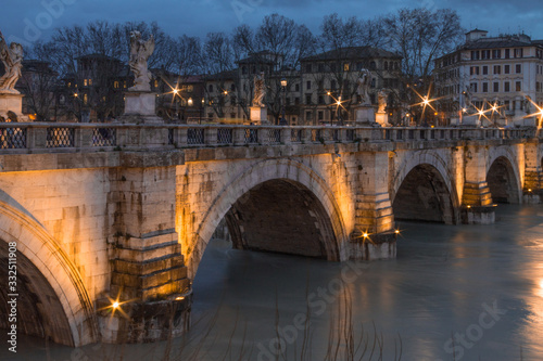 Tiber river bridge at night with light set, Rome, Italy. Long exposure.