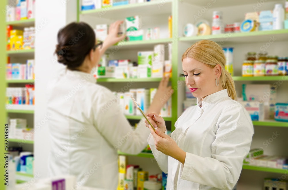 Stacking medicine on shelves in pharmacy