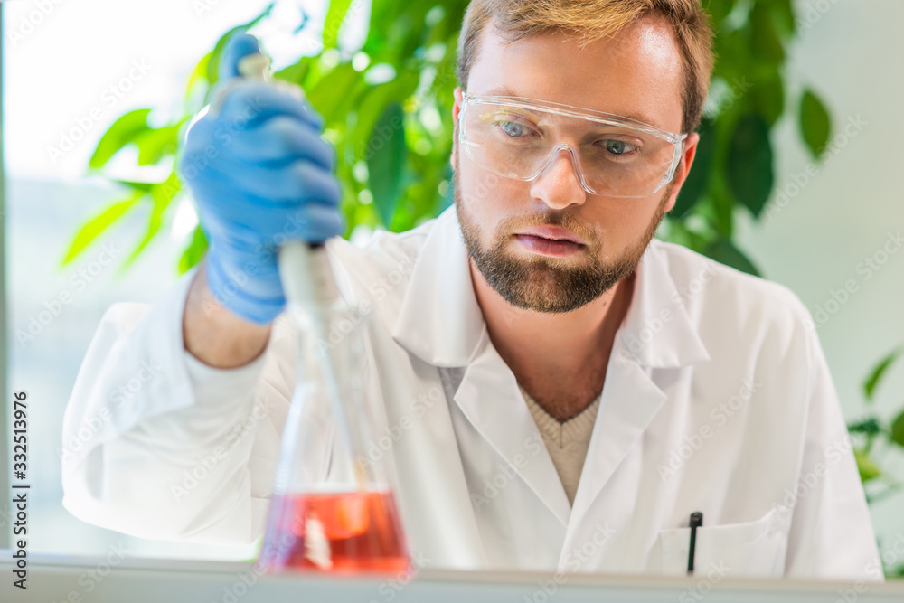 Scientist and students working in lab. Doctor teaching interns to make blood analyzing research. Coronavirus, chemistry, bacteriology, virology and health care Scientist and students working in lab. Doctor teaching interns to make blood analyzing research. Coronavirus, chemistry, bacteriology, virology and health care