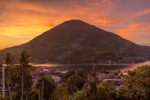 Gunung Api  or mountain of fire volcano  seen from fort Belgica on vivid red sunset that evening gave some surreal feeling. Landmark object, ring of fire, Banda Neira, maluku, Indonesia photo