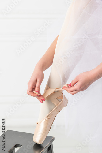 Closeup view of tying pointe shoes (ballet shoes)