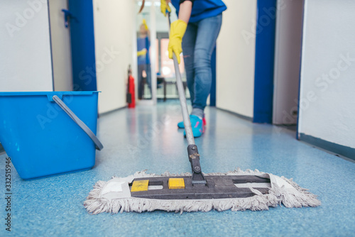 Close-up of cleaners moping the floor photo