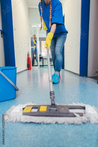Close-up of cleaners moping the floor