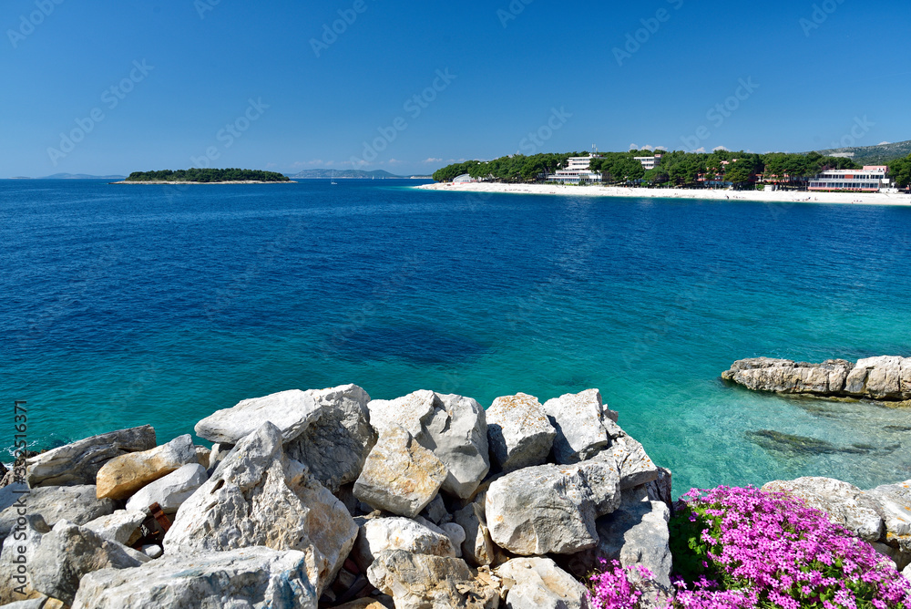 The snow white beach in famous and beautiful Primosten town in Dalmatia - popular tourist destination in Dalmatia. Croatia The snow white beach in famous and beautiful Primosten town in Dalmatia - popular tourist destination in Dalmatia. Croatia