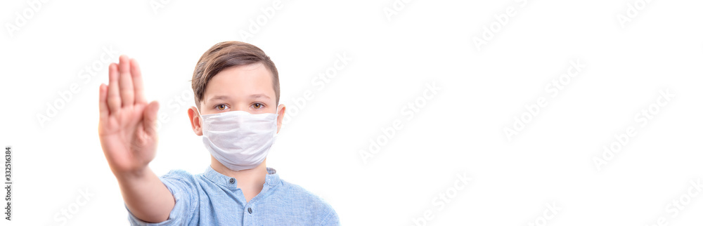 Handsome brunette boy in medicime mouth mask showed stop coronovirus banner. Stay home stay safe Handsome brunette boy in medicime mouth mask showed stop coronovirus banner. Stay home stay safe