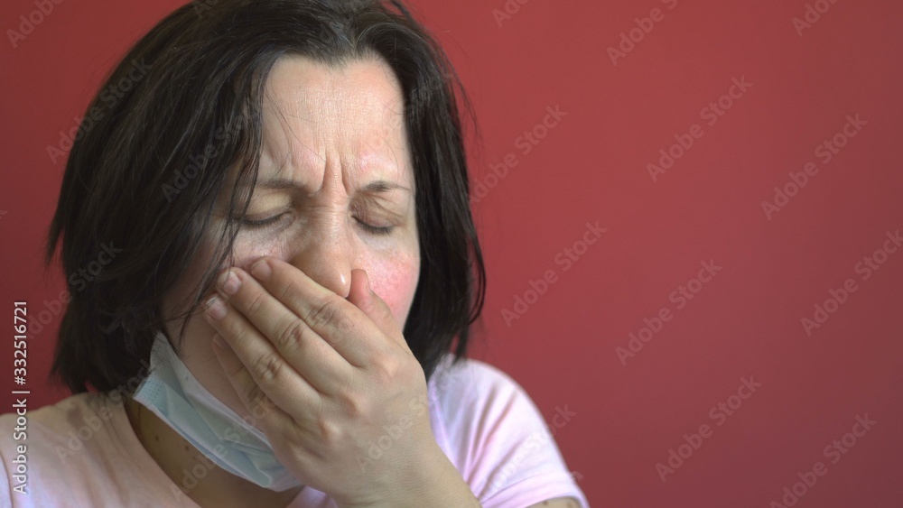 The young woman is ill. Coughing. Antibacterial protection. Dark hair. Viral infection. Close-up. The young woman is ill. Coughing. Antibacterial protection. Dark hair. Viral infection. Close-up.