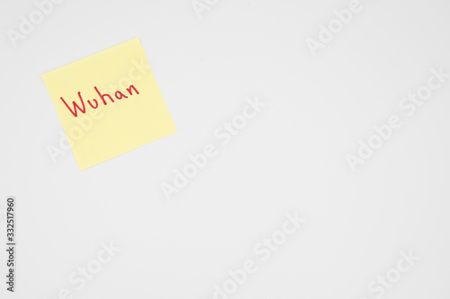 Wuhan in bold red lettering on a yellow sticky note with copyspace