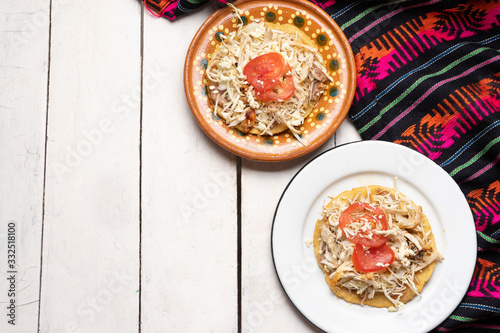 Mexican salbutes with shredded chicken on white background photo