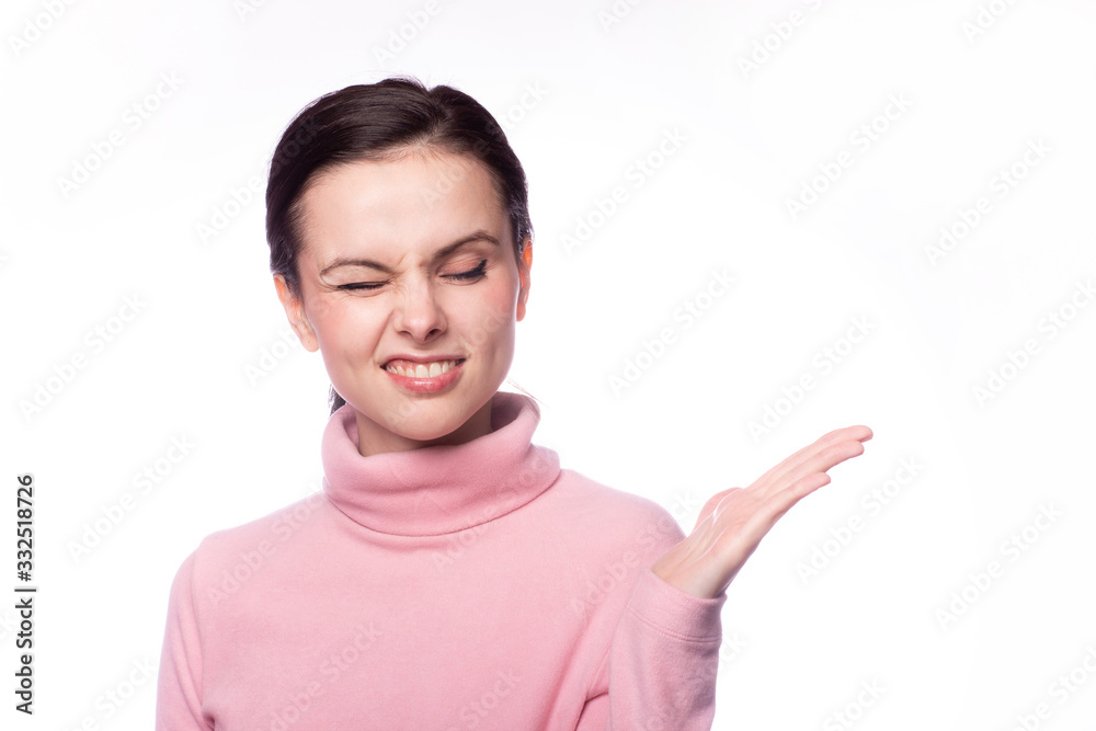 beautiful girl in a pink turtleneck talking on the phone on a white background beautiful girl in a pink turtleneck talking on the phone on a white background