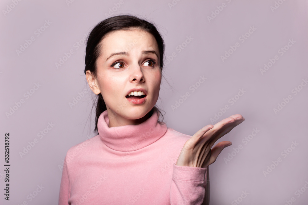beautiful girl in a pink turtleneck on a gray background beautiful girl in a pink turtleneck on a gray background