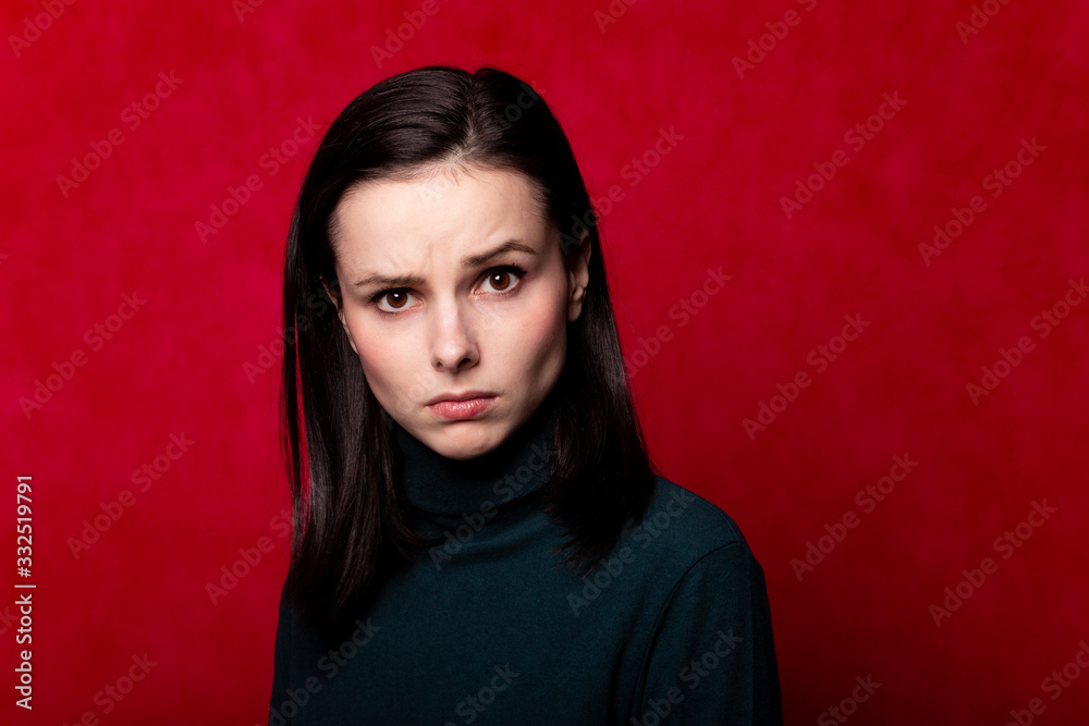 girl in a green turtleneck, portrait on a red background girl in a green turtleneck, portrait on a red background